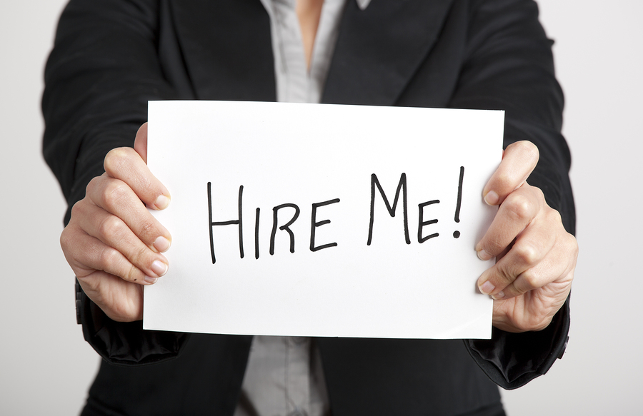 bigstock-Business-woman-holding-a-card-29452100